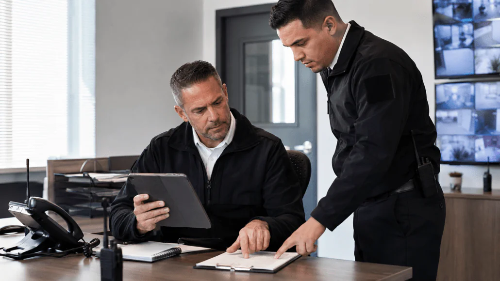Security guards reviewing digital post orders on a tablet
